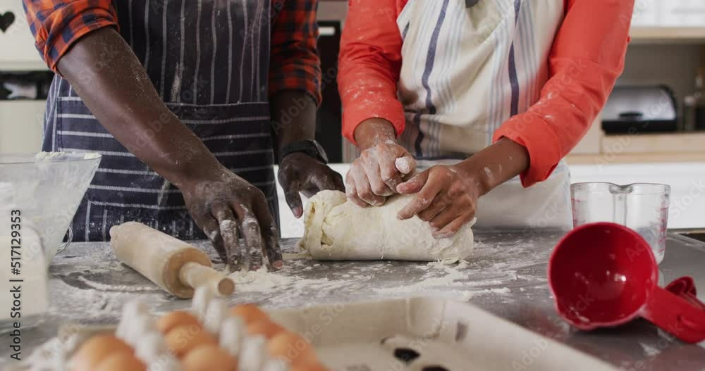 Video of midsection of african american couple baking together, preparing dough Video of midsection of african american couple baking together, preparing dough