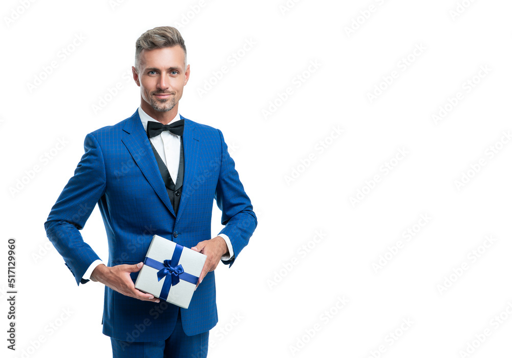 smiling mature man in suit with birthday present isolated on white smiling mature man in suit with birthday present isolated on white