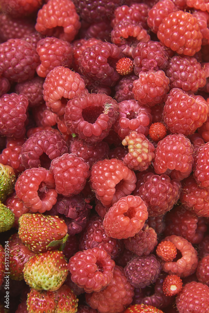 Full frame ripe red raspberries and strawberries. Full frame ripe red raspberries and strawberries.