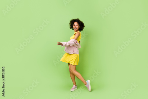Full size photo of good mood excited energetic positive lady have fun dancing isolated on green color background