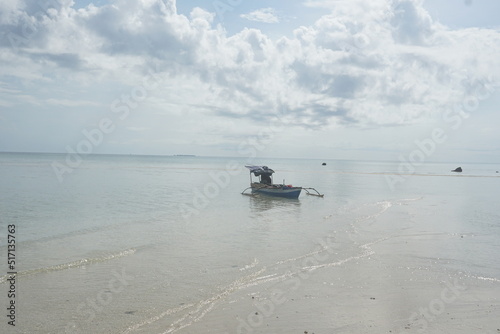 fishing boat on the Sangalaki Island beach photo