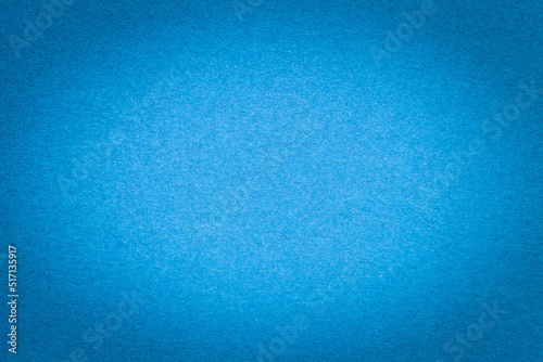 Texture of vintage light blue paper gradient background with dark vignette. Structure of craft cerulean cardboard