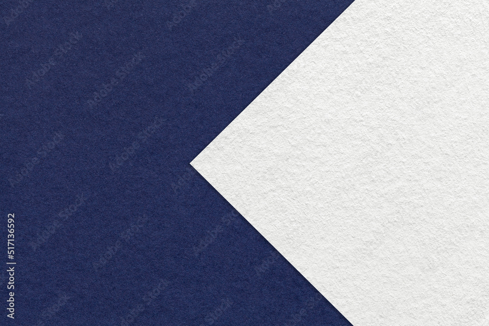 Texture of navy blue paper background, half two colors with white arrow, macro. Structure of craft denim cardboard. Texture of navy blue paper background, half two colors with white arrow, macro. Structure of craft denim cardboard.