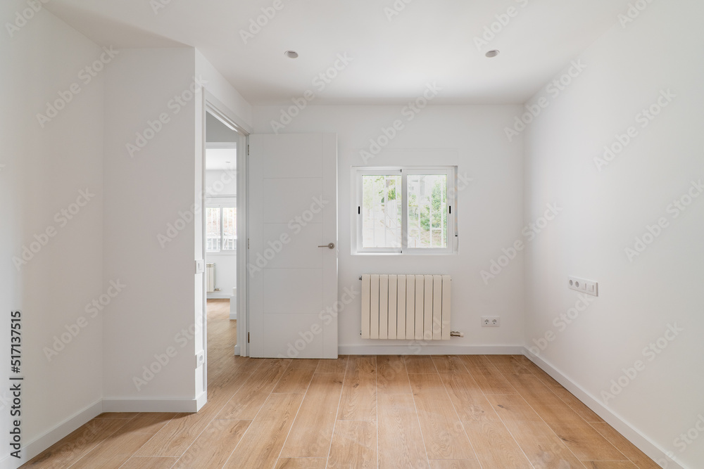 Empty white room with window and natural light. Interior of the freshly renovated room. Empty white room with window and natural light. Interior of the freshly renovated room.