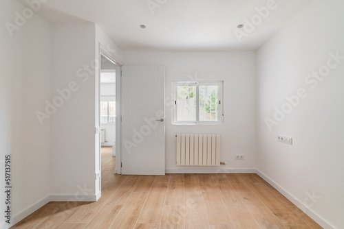 Empty white room with window and natural light. Interior of the freshly renovated room.