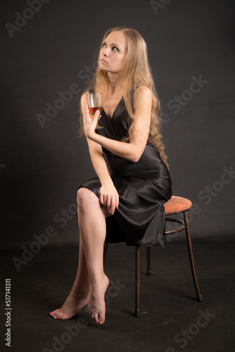 slim woman in dress with a glass of wine