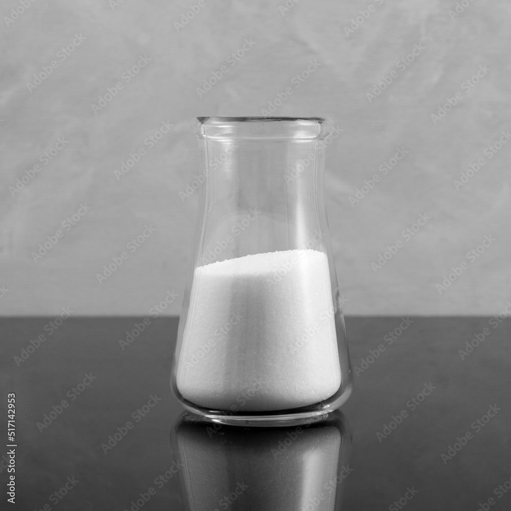 Glass flask of Sodium chlorate. White chemistry crystalline powder