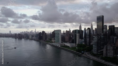 Wallpaper Mural Aerial view of the Lenox hill cityscape and the East river, cloudy dusk in New York, USA - pan, drone shot Torontodigital.ca