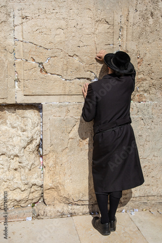 Jewish man praying at the Western wall