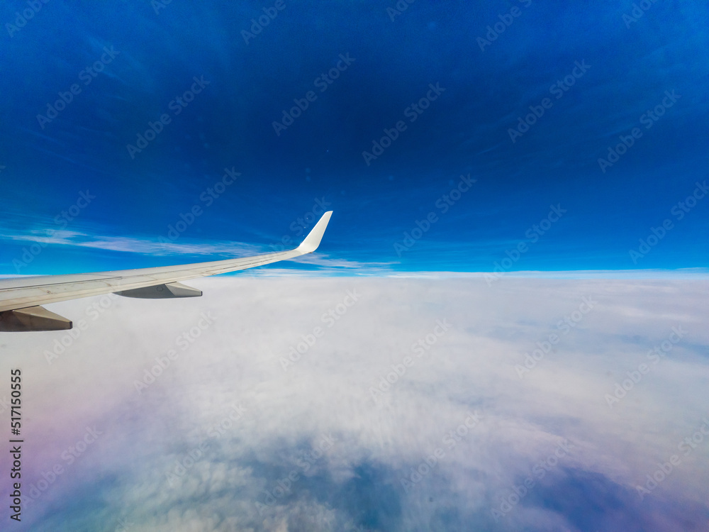 View from an airplane window onto clouds View from an airplane window onto clouds