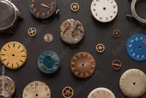 Dials from old, Soviet watches on a dark background. Top view. Copy space