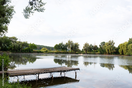 A summer landscape of nature showing masonry above the lake in the morning