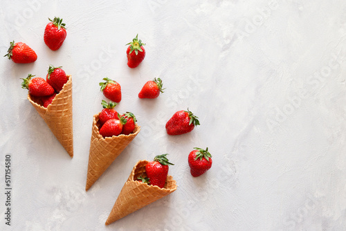 Fresh strawberries in waffle cones. Summertime mood. Flat lay, top view