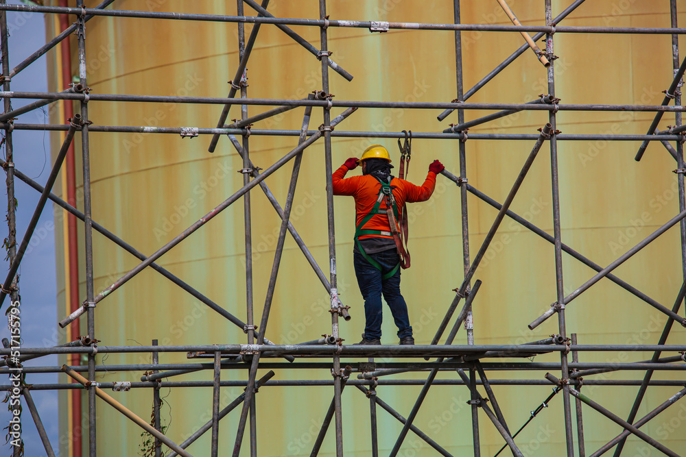 Worker male assembly in progress storage new tank  oil inspection scaffolding