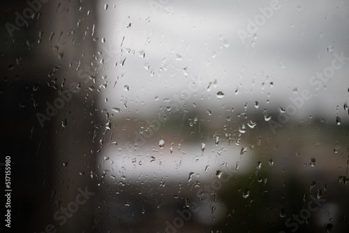 rain on glass. Raindrops on window glass. Selective focus. Rainy city background