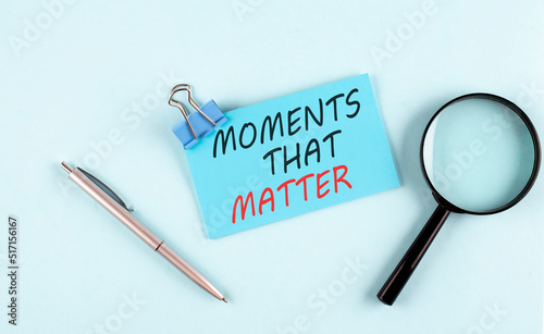 MOMENT'S THAT MATTER text written on sticky with magnifier and pen, business concept photo