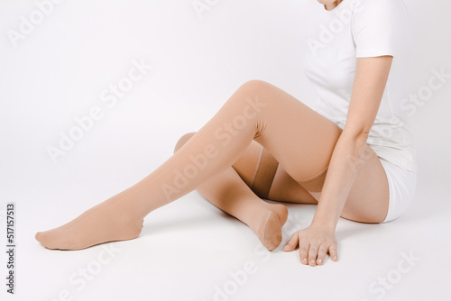 Beige compression stockings isolated on a white background.