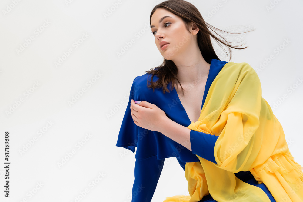 patriotic ukrainian young woman in blue and yellow outfit posing isolated on grey. patriotic ukrainian young woman in blue and yellow outfit posing isolated on grey.