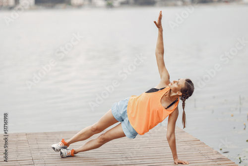 Woman doing workout in a park by the water