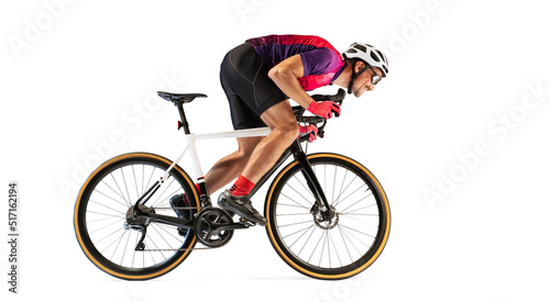 Portrait of man, professional cyclist training, riding isolated over white studio background. Side view