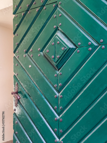 Close-up of green wooden door.