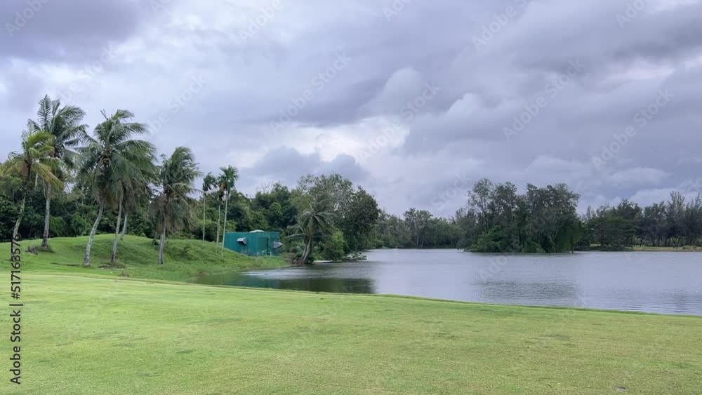 Lake and small island views. The trees swayed in the strong wind. Lake and small island views. The trees swayed in the strong wind.