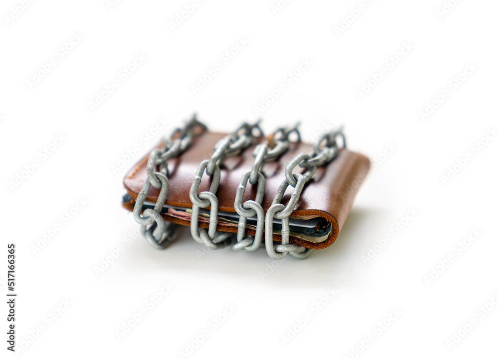 Chain bundle around leather wallet concept of end spending concept. Chain bundle around leather wallet concept of end spending concept.