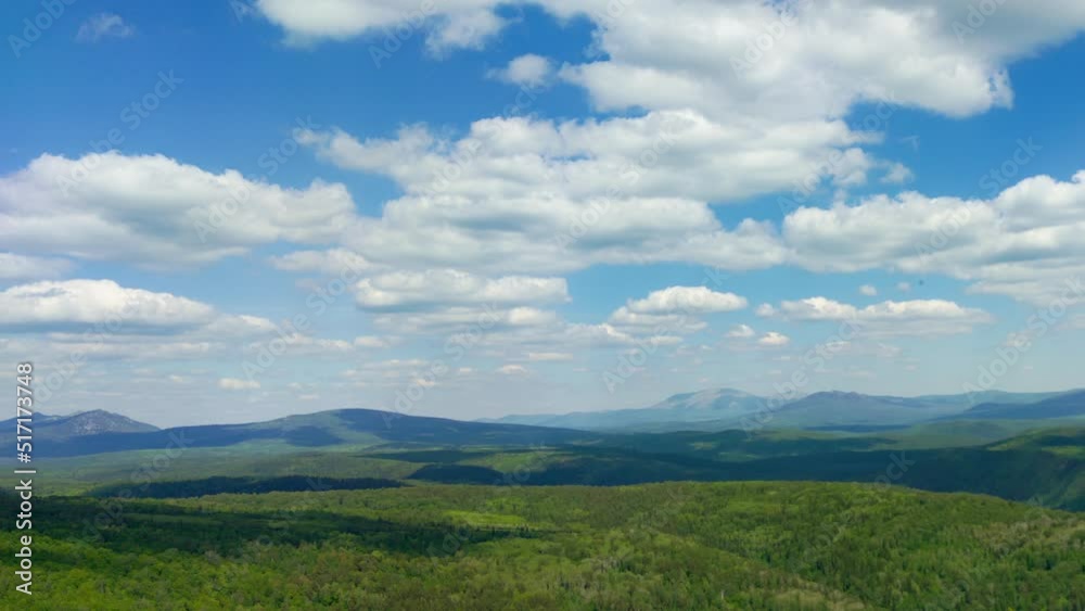 Amazing natural landscape with clouds floating across sky casting shadows on green hills. Timelapse. Beautiful scenery of mountains covered with trees, bushes, grass. Picturesque countryside Amazing natural landscape with clouds floating across sky casting shadows on green hills. Timelapse. Beautiful scenery of mountains covered with trees, bushes, grass. Picturesque countryside