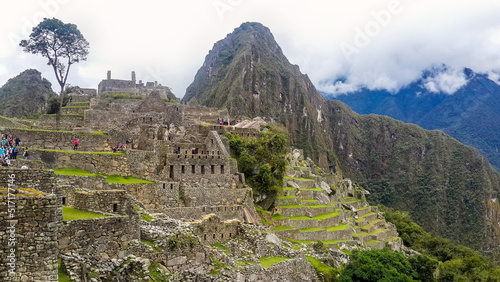 Stunning Machu Picchu city view high angle. Spectacular nature scenery and historical background with copy space. Machu Picchu is an Inca citadel set high in Andes Mountains in tropical forest in Peru