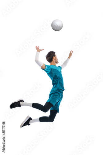 Portrait of young man, volleyball player in motion, training, playing isolated over white studio background. Winning game