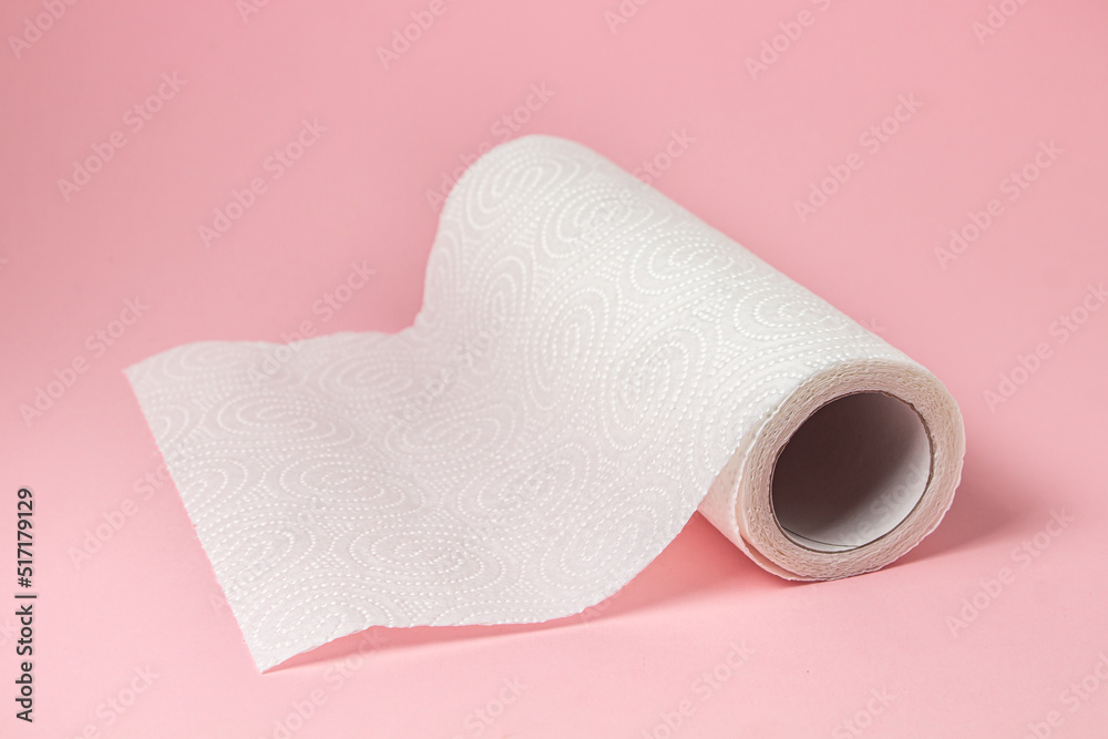 Paper towel on a pink background. Means for cleaning and hygiene. Disposable towel Paper towel on a pink background. Means for cleaning and hygiene. Disposable towel