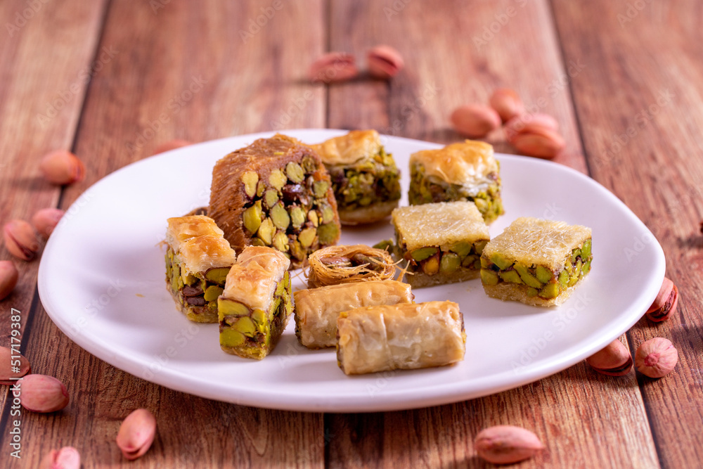 Mix pistachio baklava. Assortment of pistachio baklava on a wooden background. Turkish cuisine desserts. close up Mix pistachio baklava. Assortment of pistachio baklava on a wooden background. Turkish cuisine desserts. close up