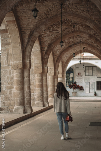 Woman is walking in courtyard of ancient St.Lazarus church in Larnaca