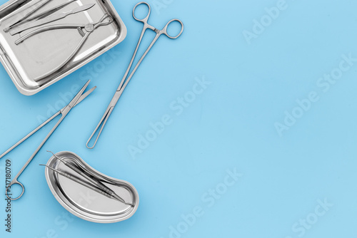Medical equipment tools instruments in steel tray at doctor desk