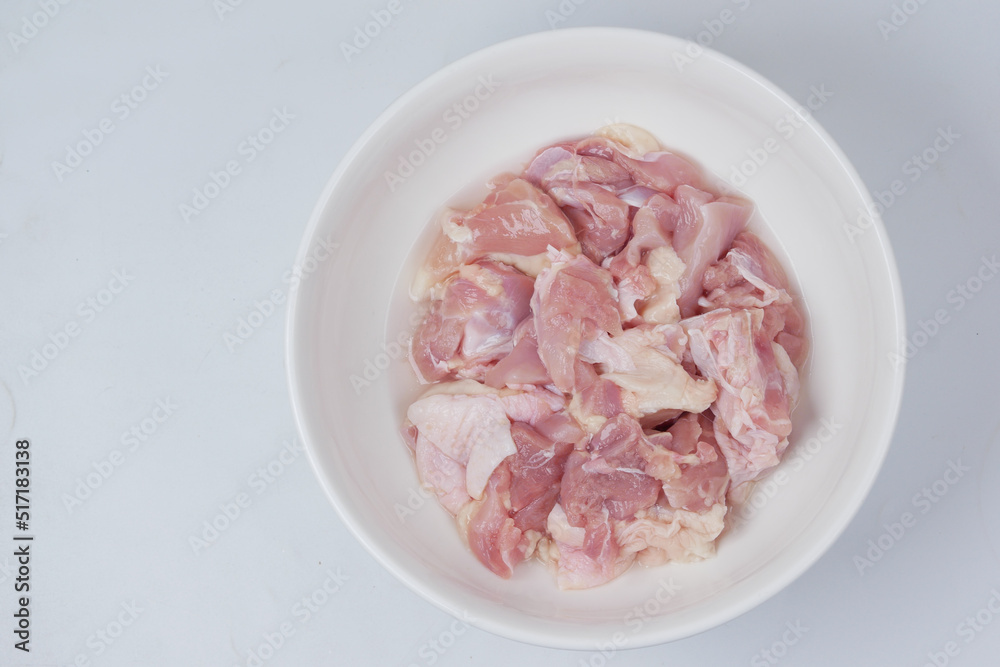 boneless slice of chicken meat in a bowl on white boneless slice of chicken meat in a bowl on white