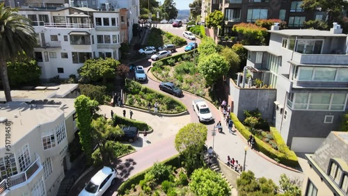 cars driving down the iconic winding Lombard Street in San Francisco, CA, at daytime