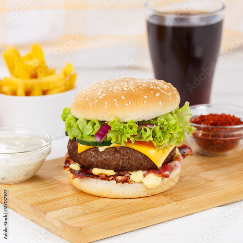 Hamburger Cheeseburger meal fastfood fast food with cola drink and French Fries on a wooden board square © Markus Mainka