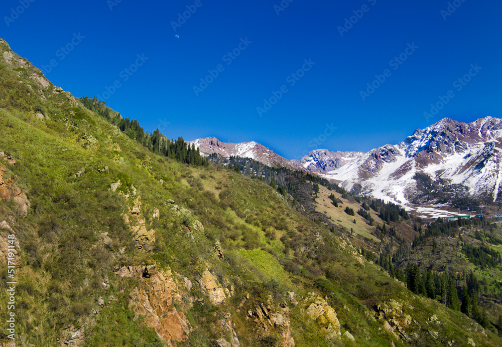 Almaty Kazakhstan mountains in Medeu province with snow cover on the peak in summer