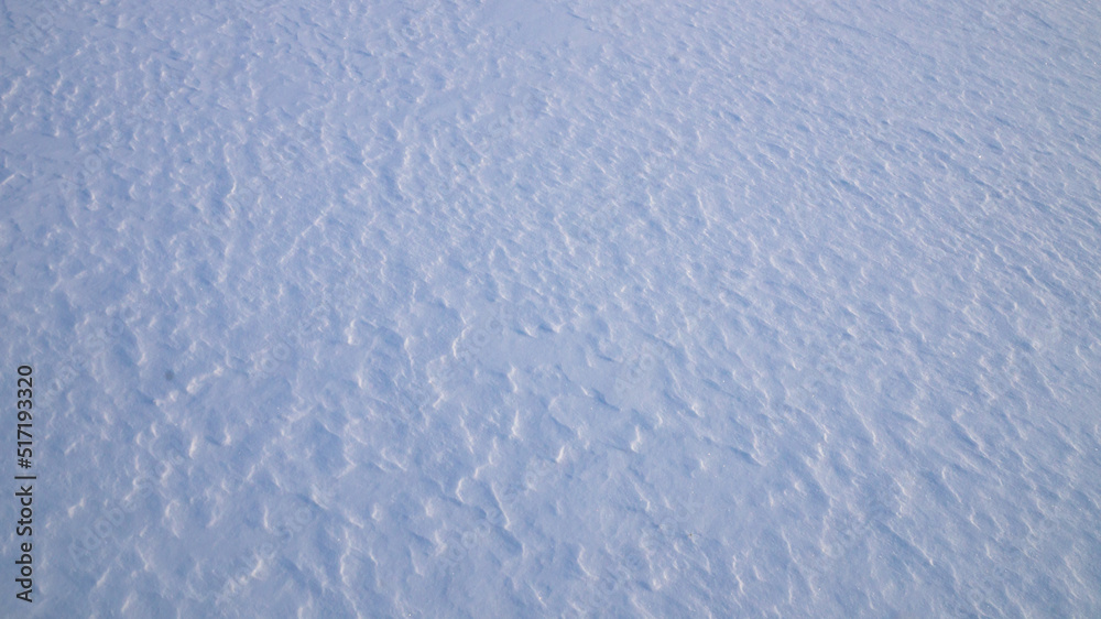 Texture of white snow with natural roughness.