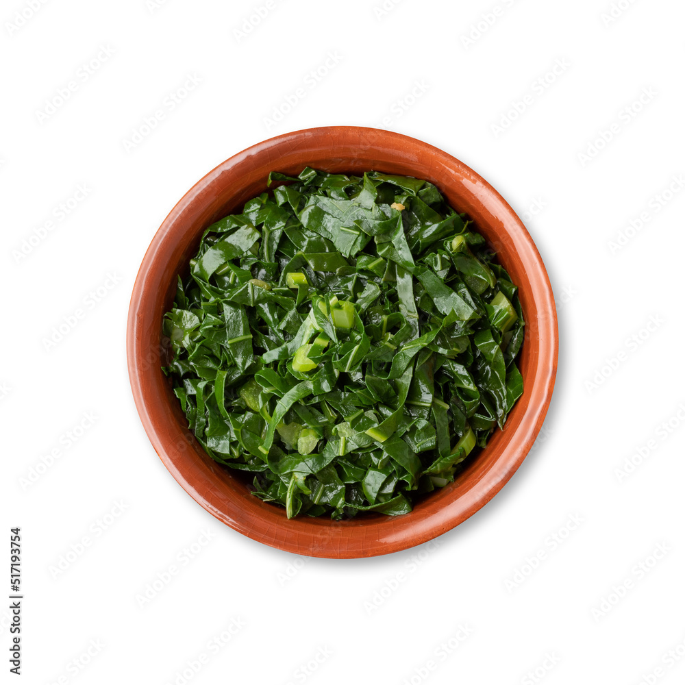 Cooked kale strips, typical brazilian feijoada sidedish in a bowl isolated over white background Cooked kale strips, typical brazilian feijoada sidedish in a bowl isolated over white background