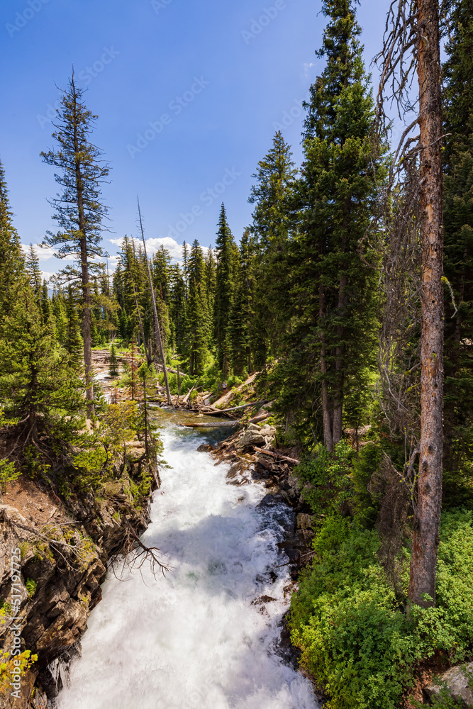 Sunny view of the Hidden Falls in Grand Teton National Park Sunny view of the Hidden Falls in Grand Teton National Park