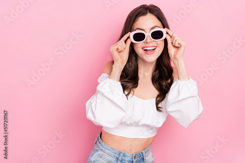 Photo of adorable attractive female in sunglass relaxing summer holidays vacation isolated on pink color background © deagreez