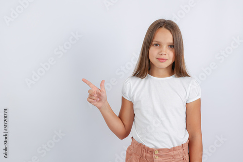 girl pointing at empty space. High quality photo