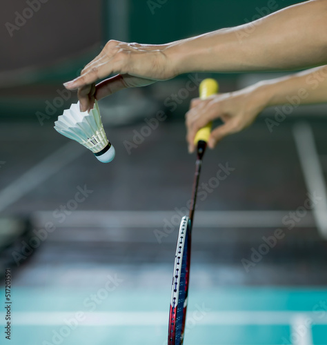 Badminton player holding Badminton shuttlecock and racket serving in sports game, Badminton sports