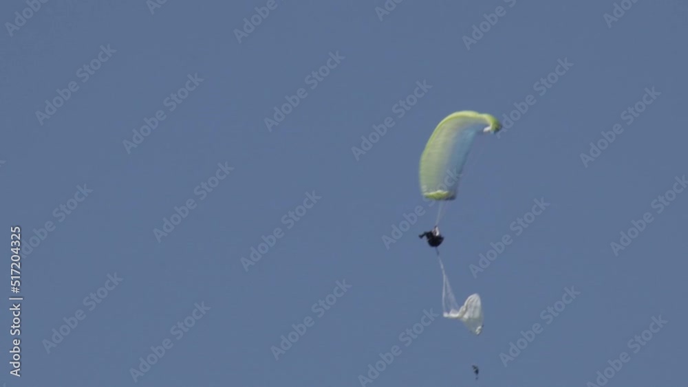 Paraglider opening the reserve parachute after a malfunction of the paragliding wing. Extreme skydiving. Paraglider opening the reserve parachute after a malfunction of the paragliding wing. Extreme skydiving.