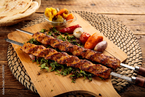 Chicken seekh Kebab served in a wooden cutting board isolated on wooden background side view photo