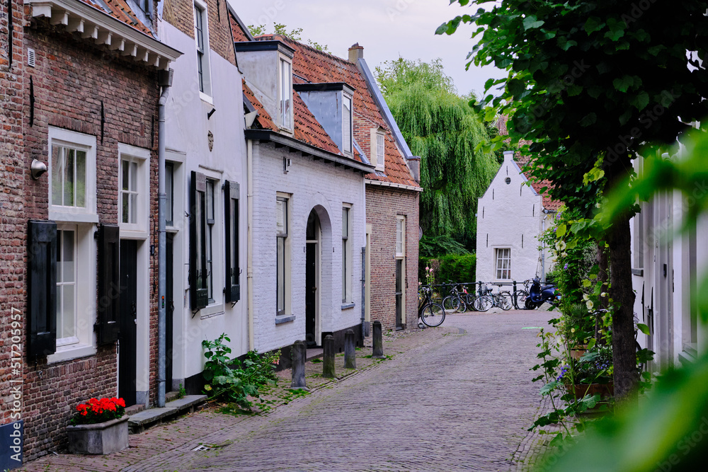 Amersfoort, The Netherlands, July 6, 2022. Empty side streets with brick paving on a quiet summer’s evening. Selective focus.