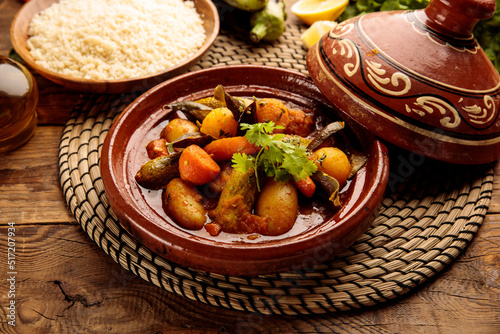 Moroccan tagine with rice served in a dish isolated on wooden background side view