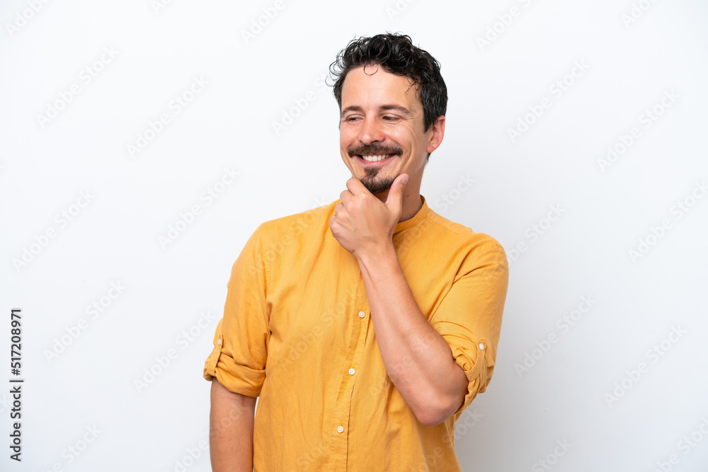 Young man with moustache isolated on white background looking to the side and smiling Young man with moustache isolated on white background looking to the side and smiling