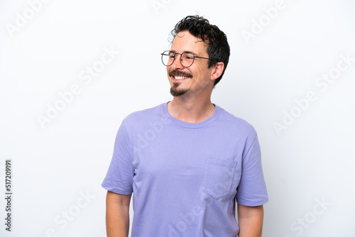 Young man with moustache isolated on white background looking to the side and smiling © luismolinero